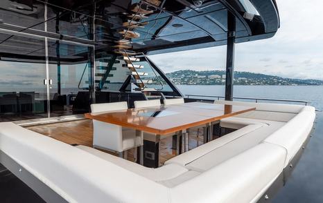 Superyacht Onyx's aft deck with shaded dining table 