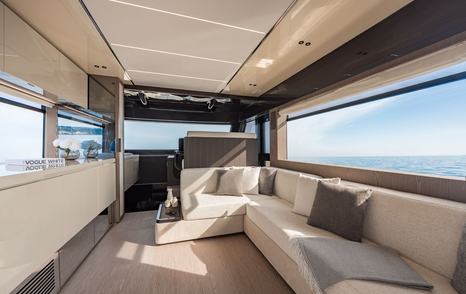 Invictus ST550 motor yacht interior with helm station and L-shaped sofa
