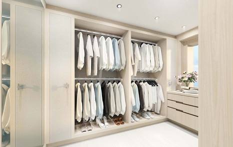 Walk-in wardrobe with motor yacht Project Fun, with cream details and clothes in wardrobe