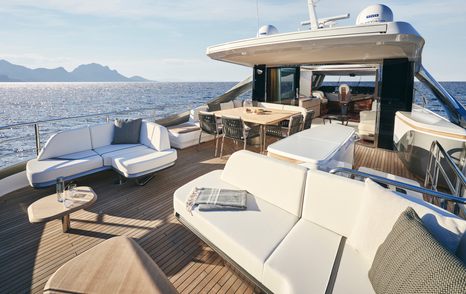Princess X80 motor yacht flybridge with alfresco dining and white seating