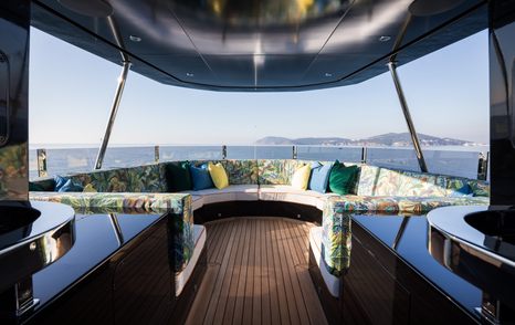 KING BENJI's upper deck features ample seating areas, with cushions covered in vibrant materials and patterns