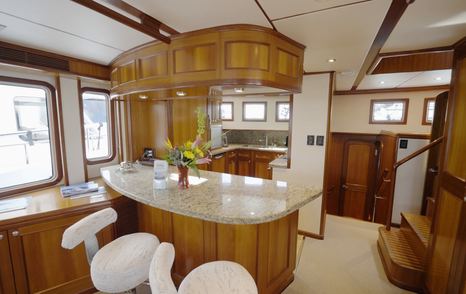 Nordhavn 75 EYF galley breakfast bar with raised pilothouse staircase and companionway