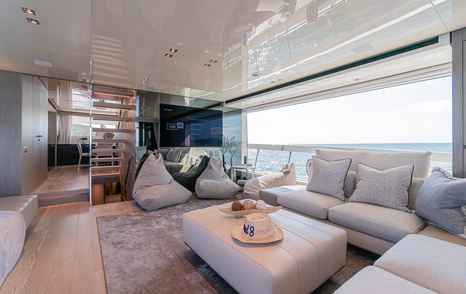 Motor yacht Hard 8's main saloon with L-shaped sofa and bean bags