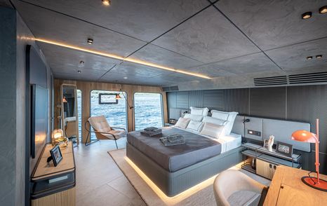 Numarine 30XP's owner's suite with seating area and floor-to-ceiling windows 