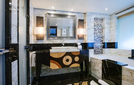 Ensuite bathroom on motor yacht W with marble detailing and a black basin