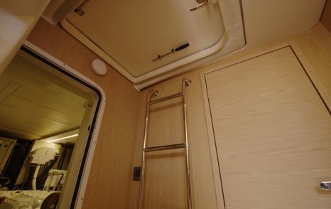 Beneteau Grand Trawler 63 crew area with engine room access and companionway ladder