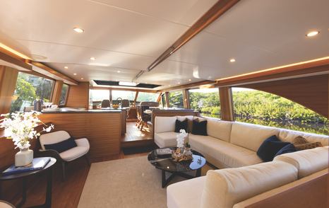 Palm Beach PB85 Sedan motor yacht main saloon with L-shaped cream furniture 
