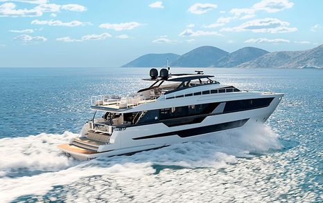 Side angle view of Ferretti 1000 underway, surrounded by sea with land in far distance 