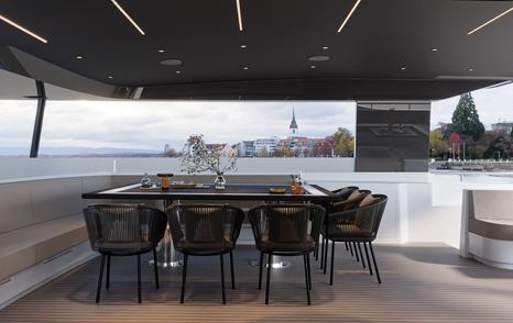 Rendering of VisionF 65 Hybrid Catamaran aft deck shaded alfresco dining area 