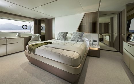 Master cabin on board Princess Y85. Central berth with large window to port side and mirror on starboard.