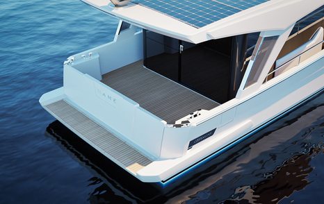 Aft cockpit of the motor yacht Greenline 42 with dining table and fold-down transom