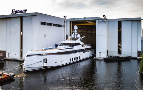 Feadship Project 706 underway being escorted out of Feadship construction facility