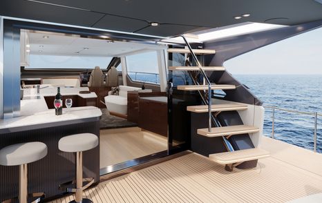 Aft deck of the Fairline Squadron 58. Steps ascending to flybridge on starboard side with wet bar on port side. 