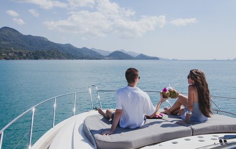 Couple relaxing on deck of a charter yacht