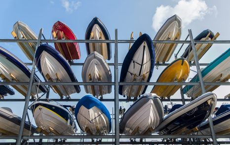 small boats stacked on shelves