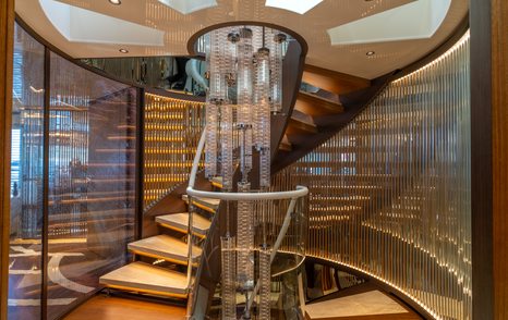 Designer chandelier suspended by staircase onboard superyacht ETERNAL SPARK