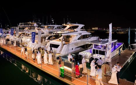 Motor yachts berthed at Qatar Boat Show at night