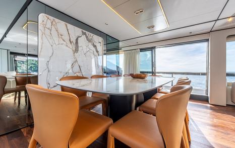 Motor Yacht Together main saloon dining area with orange chairs 