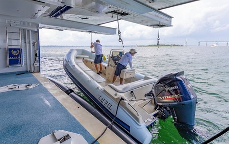 Yacht crew on superyacht launching yacht tender for use