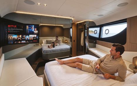 Rendering of ICONA 70 motor yacht cabin with man on bed