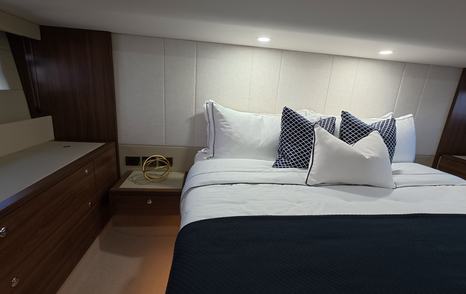 Maritimo M50 full beam owner’s cabin bed detail with upholstered headboard and side cabinetry