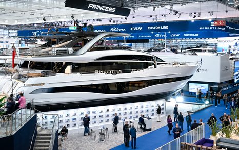 Princess motor yacht on display at boot Dusseldorf with visitors walking by on blue carpet