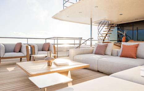 Rendering of Tenth Moonen 122 Martinique motor yacht aft deck with L-shaped white sofa 