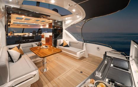 Riviera-6000-Sport-Yacht-Platinum-Edition-Review-aft-cockpit-entertaining-area-evening-setup