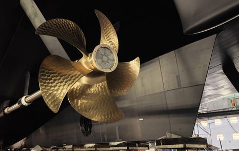 Close up of Superyacht Boardwalk propellers beneath hull in Lurssen shipyard 