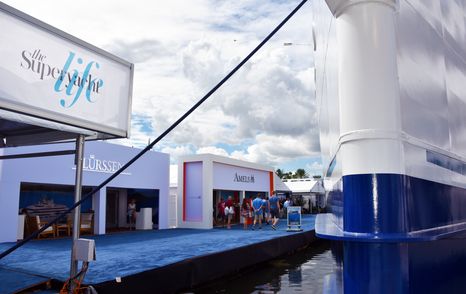 Exhibitor stands at Superyacht Village FLIBS, fronted by blue carpet