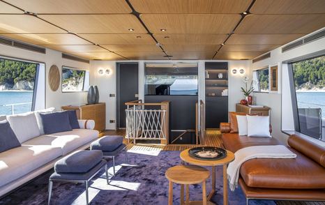 Motor yacht Numero Dix upper deck lounge with leather chaise lounge 