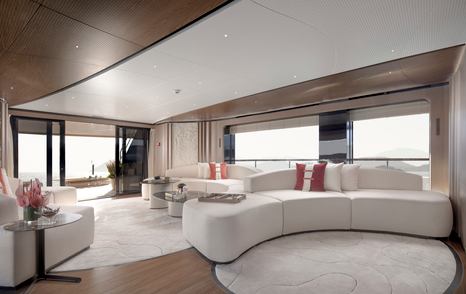 Sirena 42M superyacht main salon with curved white sofa 