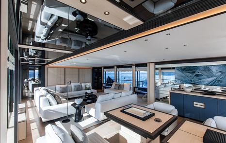 Superyacht Andala main saloon white plush seating and pop up TV