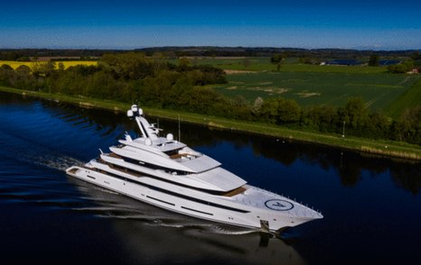 Overlooking Lurssen 'Project Hawaii' underway, surrounded by rolling hills in background.