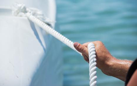 deck crew holding mooring line