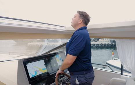 Delta-Powerboats-72-Review-standing-at-helm-jack-haines