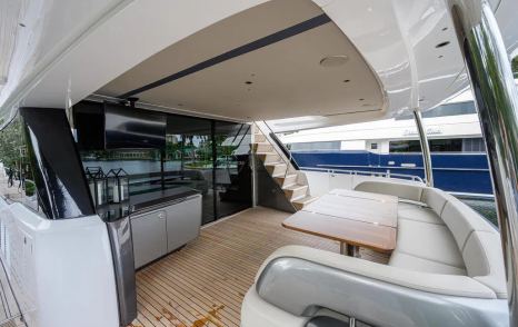 Aft of Motor Yacht Escape with table and U-shaped seating