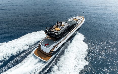 Aft view running shot of Sunseeker 75 Sport Yacht, surrounded by sea.