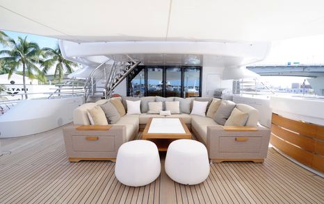 Bridge deck lounge seating area on the Amels 242 Casino Royale with sofas and teak decking.