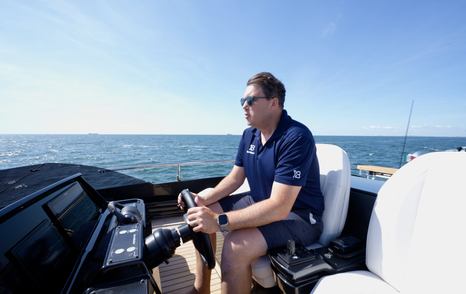 Pershing GTX70 Jack Haines at flybridge helm underway during Venice sea trial