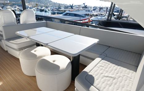 Pearl 73 flybridge dining table with wraparound seating and stools