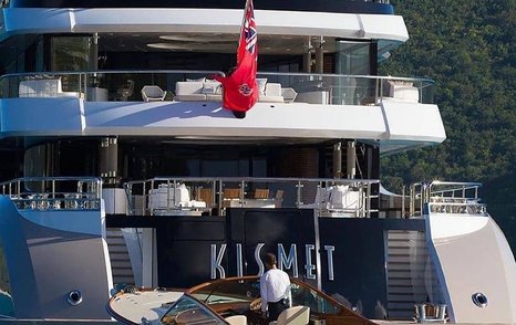 Close up aft view of superyacht KISMET, exterior furniture visible on the decks with name plate centre.