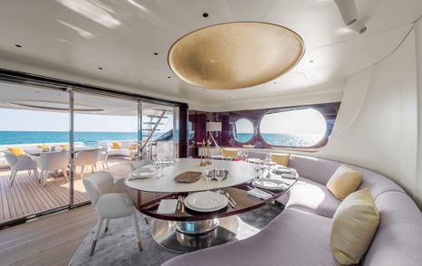 Azimut motor yacht Tanelorn dining room with curved seating 