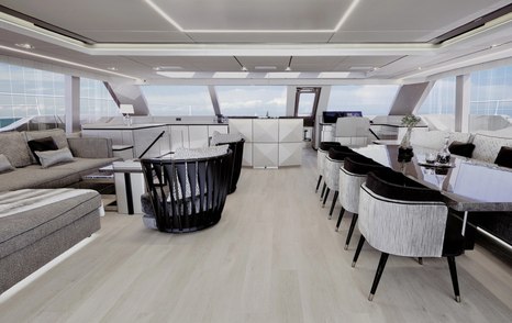 Sunreef Yachts 80 Sunreef Power catamaran main saloon with marbled dining area and grey furniture