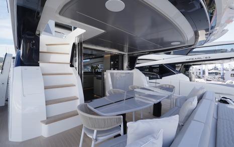 Pearl 73 cockpit dining area beneath the flybridge overhang
