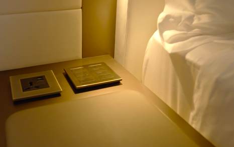 Bedside controls, charging points and reading light in a Gulf Craft Majesty 145 VIP cabin