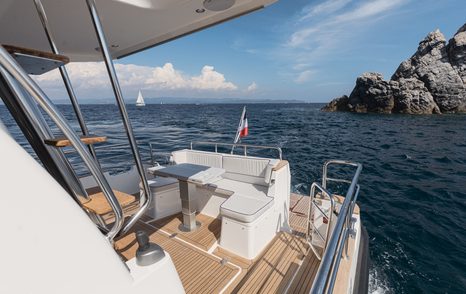 Nord Star 49+ motor yacht aft deck with U-shaped grey seating 