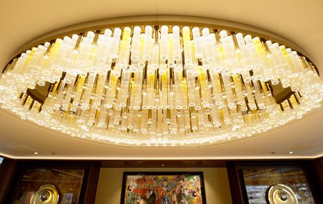 Large chandelier above the dining table in the main saloon of the Amels 242 Casino Royale.