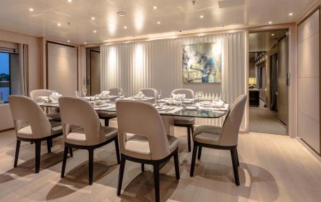 Superyacht Kinda main saloon dining area with abstract art