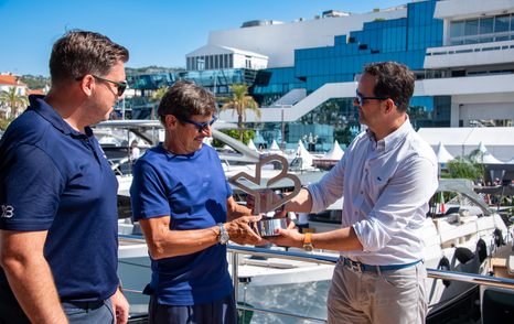 Kevin Bodington and Jack Haines handing over the YachtBuyer Hall of Fame Trophy for the Bluegame BG42 at the Cannes Yachting Festival